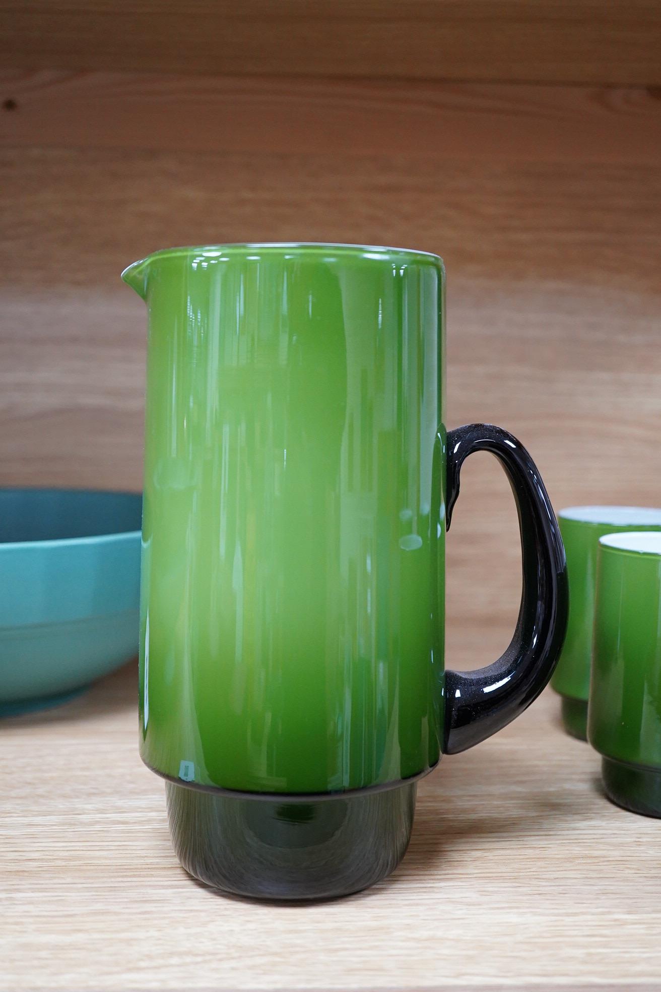Michael Bang for Holmegaard glass, a green cased jug and six mugs with stepped bases, largest 20cm high